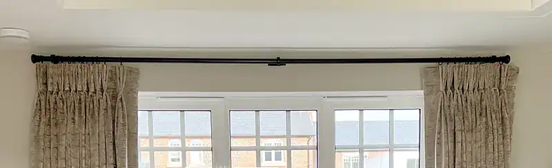 Wrought iron curtain pole with button finials finished in black